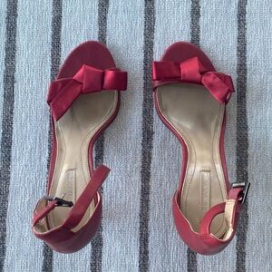 Red BCBG MaxAzria high heel sandals.
